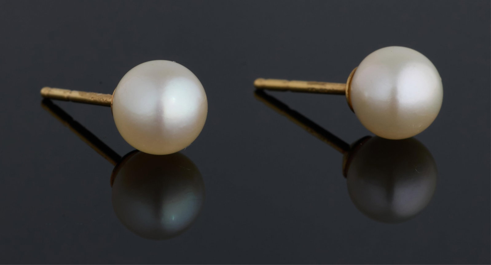 Pair of 18K Yellow Gold Mikimoto Pearl Studs, App. Total Wt.- 2 grams. (2 Pcs.): Pair of 18K Yellow Gold Mikimoto Pearl Studs, each 7mm light cream colored pearl with a slightly rosy overtone, App. Total Wt.- 2 grams. (2 Pcs.) Please Note: All assessments of gemstone weight, color