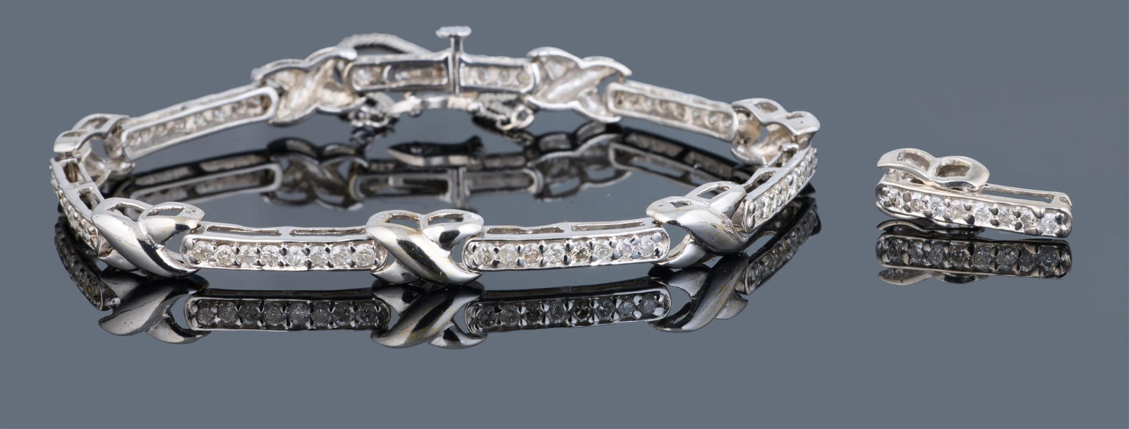 18K White Gold Diamond Bracelet, App. Total Wt.- 17.6 grams, L.- 5 3/8 in. (2 Pcs.): 18K White Gold Diamond Bracelet, the channel set links bearing approximately 1.89 carats total weight diamonds, with an additional diamond mounted link, App. Total Wt.- 17.6 grams, L.- 5 3/8 in. (2 Pc