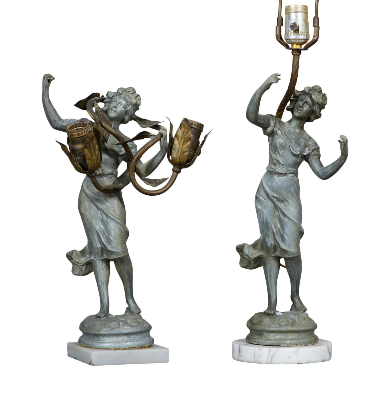 Near Pair of Spelter Art Nouveau Figural Lamps, 20th c., Double- H.- 15 1/2 in., W.- 7 in.; Single-: Near Pair of Spelter Art Nouveau Figural Lamps, 20th c., one a two-light example on a square white marble base; the other a single light example on a round white marble base, Double- H.- 15 1/2 in., W