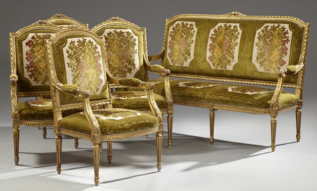 Louis XVI Style Five Piece Carved Gilt Wood Parlor: Louis XVI Style Five Piece Carved Gilt Wood Parlor Suite, 20th c., consisting of a settee and four fauteuils, with floral and leaf carved crests over reeded borders, with velvet upholstered backs, arm