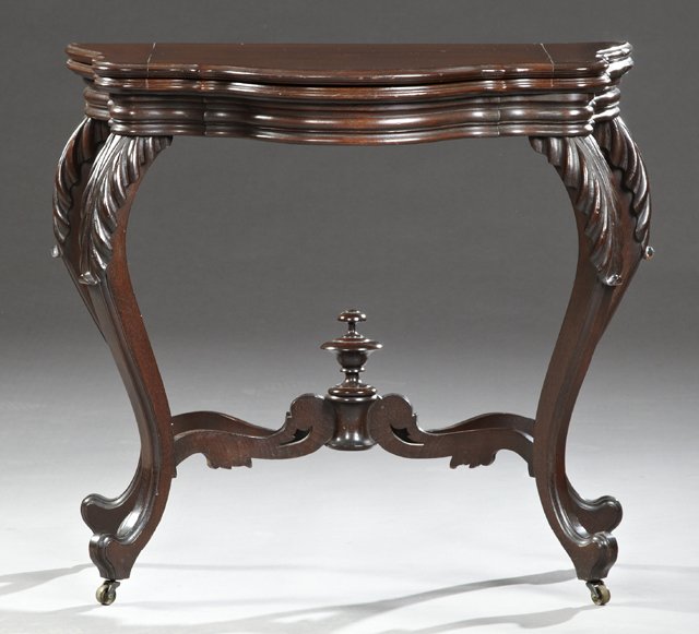 American Carved Walnut Games Table, 19ht c., with a: American Carved Walnut Games Table, 19ht c., with a shaped top over a reeded skirt, on reeded cabriole legs with well carved knees, joined by an X-form stretcher with a central turned finial, H.- 29 1