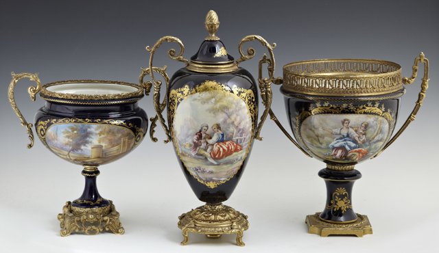 Group of Three Sevres Style Gilt Ormolu Mounted Cobalt: Group of Three Sevres Style Gilt Ormolu Mounted Cobalt Porcelain Garnitures, early 20th c., with gilt decoration and reserves of lovers in gardens, consisting of a handled covered urn, and two handled