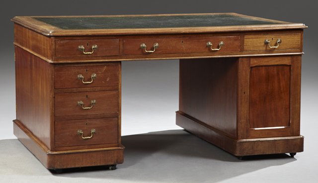 George III Style Maogany Partner's Desk, early 20th c.,: George III Style Maogany Partner's Desk, early 20th c., the rounded rectangular top with molded edge and inset leather writing surface, above a frieze fitted with three drawers to each side, raised on