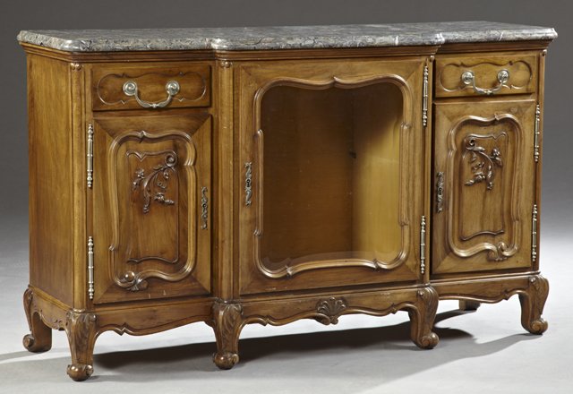 Louis XV Style Carved Walnut Marble Top Sideboard,: Louis XV Style Carved Walnut Marble Top Sideboard, early 20th c., of breakfront form, the ogee edge highly figured gray marble on a base with a central shaped beveled glass door cupboard, flanked by s