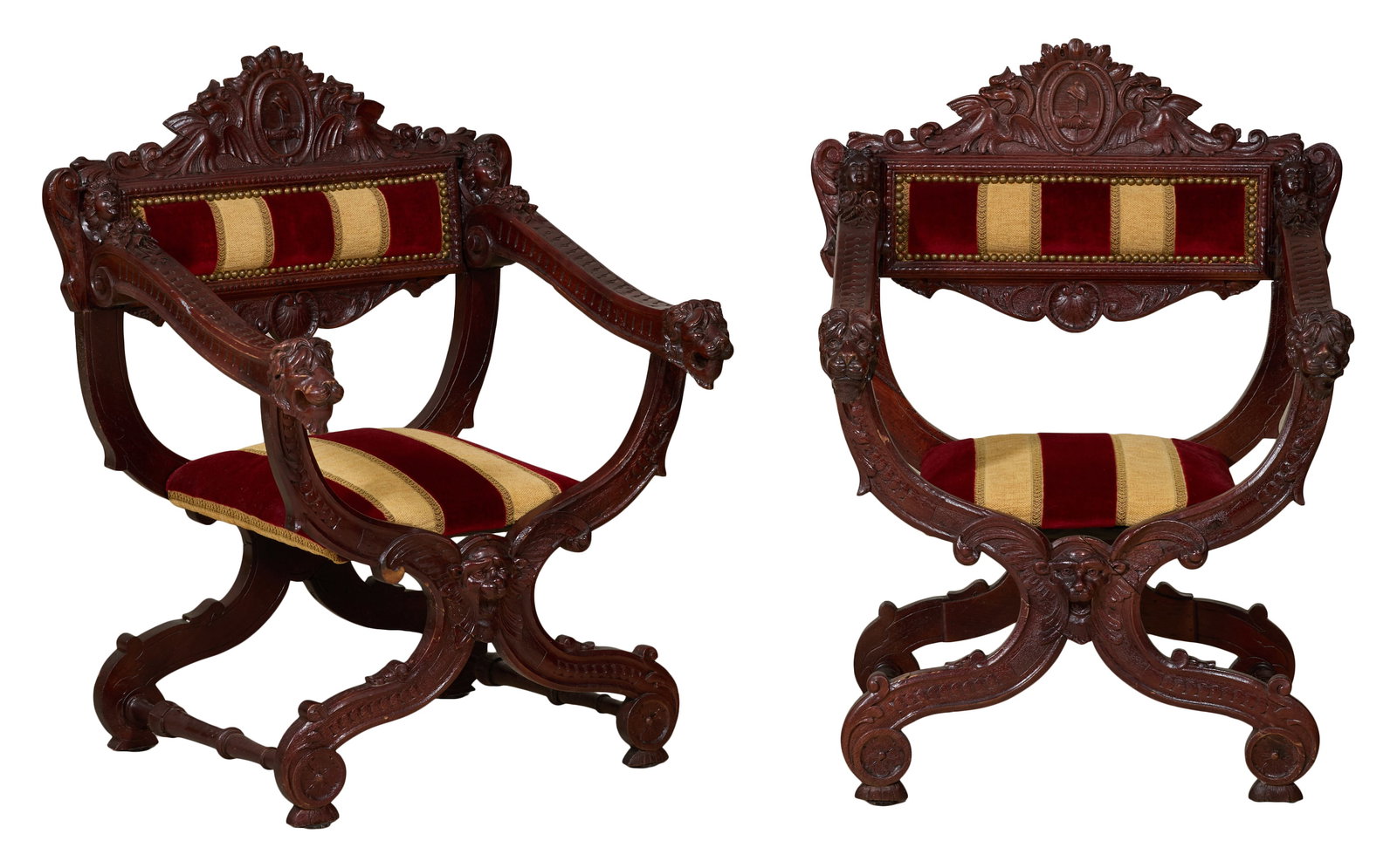Pair of Italian Carved Walnut Savonarola Chairs, mid 20th c., Each- H.- 36 in., W.- 28 in., D.- 24: Pair of Italian Carved Walnut Savonarola Chairs, mid 20th c., shield crest flanked by dragons, cherubic bust shoulders, downswept arms into lion hands, central winged bust over outswept raised scrolle