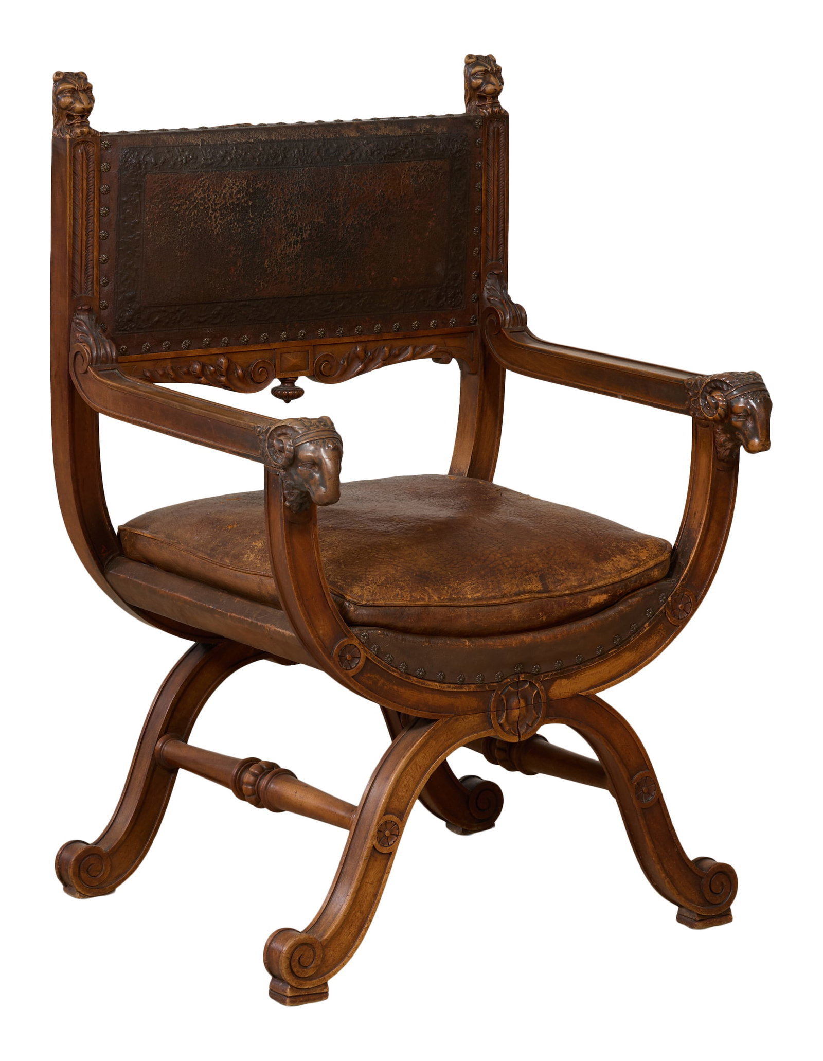 Italian Renaissance Revival Carved Walnut Savonarola Chair, late 19th c., H.- 38 1/8 in., W.- 26 1/2: Italian Renaissance Revival Carved Walnut Savonarola Chair, late 19th c., the rectangular embossed leather back flanked by zoomorphic finialed stiles, foliate scroll arms with ram's bust hands, stretc