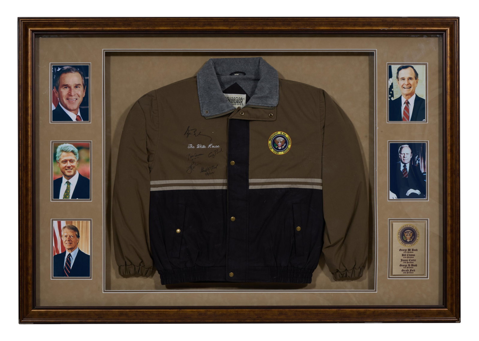 Autographed U.S. Presidential Memorabilia, 2001, Overall- H.- 39 1/2 in., W.- 57 1/2 in., D.- 3 1/2: Autographed U.S. Presidential Memorabilia, 2001, featuring a POTUS windbreaker with White House seal and insignia, signed by five presidents- Ford through G.W. Bush, presented with their photographs a