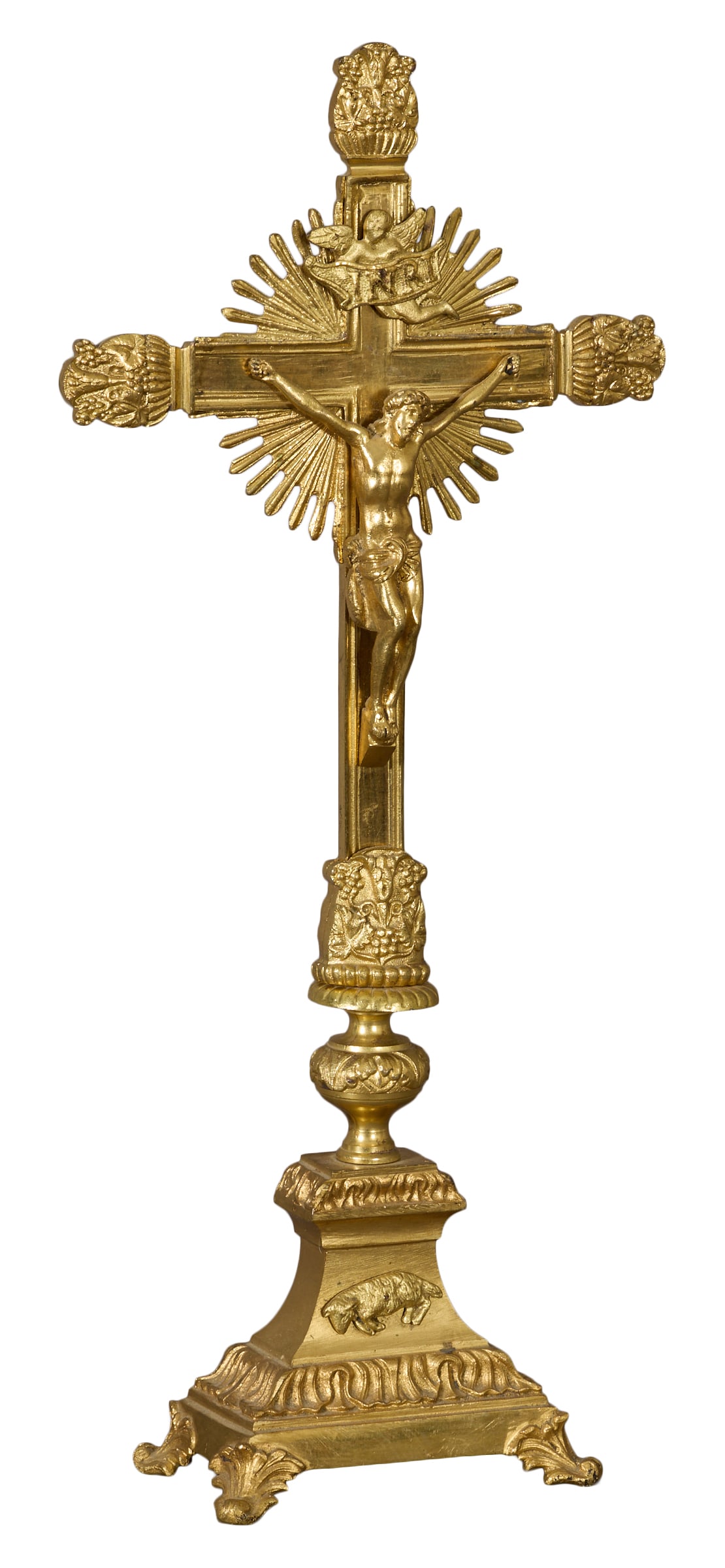 Ornate Gilt Bronze Crucifix, 20th c., H.-16 1/4 in., W.- 9 3/4 in., D.- 4 in.: Ornate Gilt Bronze Crucifix, 20th c., depicting Jesus on the cross, with relief floral decorated arms, to a tapered rectangular base, with a relief lamb decoration, H.-16 1/4 in., W.- 9 3/4 in., D.- 4