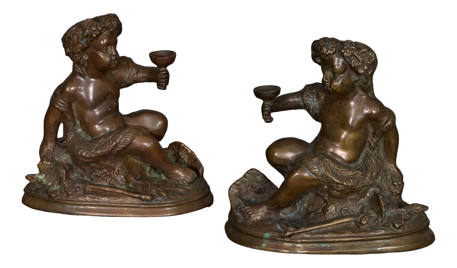 Pair of Patinated Bronze Bacchanal Figures, 19th c., Each- H.- 7 3/4 in., W.- 7 in., D.- 3 3/4 in.: Pair of Patinated Bronze Bacchanal Figures, 19th c., of putti drinking wine, on integral stepped oval bases, Each- H.- 7 3/4 in., W.- 7 in., D.- 3 3/4 in. (2 Pcs.) Provenance: Collection of Rosemary J