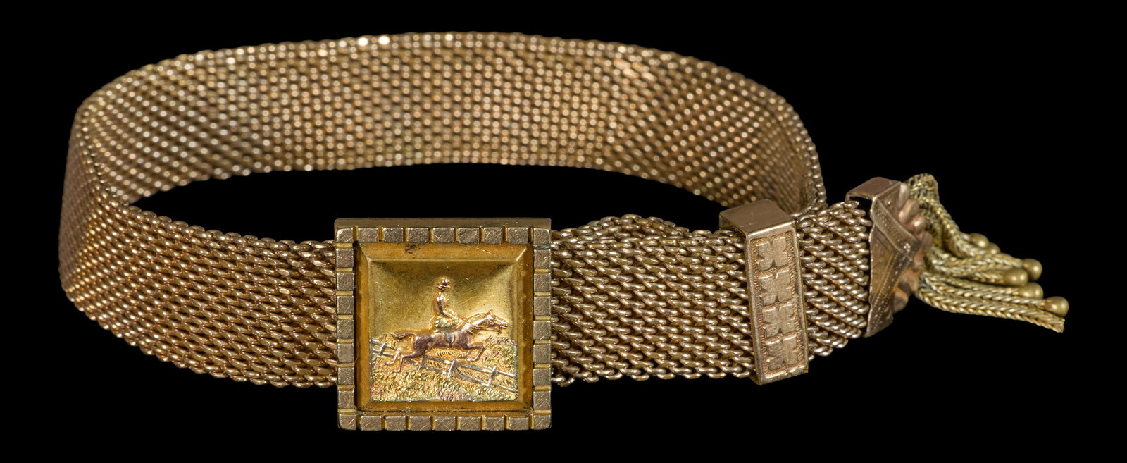 10K Yellow Gold Victorian Equestrian Bracelet, App. Total Wt.- 32.5 grams, W.- 3/4 in.: 10K Yellow Gold Victorian Equestrian Bracelet, with varicolored gold equestrian decoration on the clasp, with eight tassels on the end of the adjustable band, App. Total Wt.- 32.5 grams, W.- 3/4 in. P