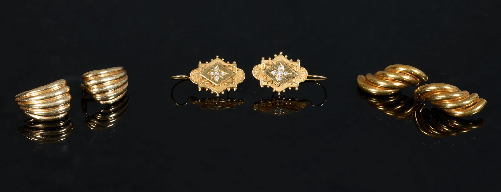 Three Pairs of 14K Yellow Gold Earrings, App. Total Wt.- 19.5 grams; Diamond Mounted- H.- 1 1/8 in.,: Three Pairs of 14K Yellow Gold Earrings, a pair of shell form earrings by Dankner, with omega backs; a pair of Italian swirled earrings, with post backs; together with a pair of Edwardian diamond moun