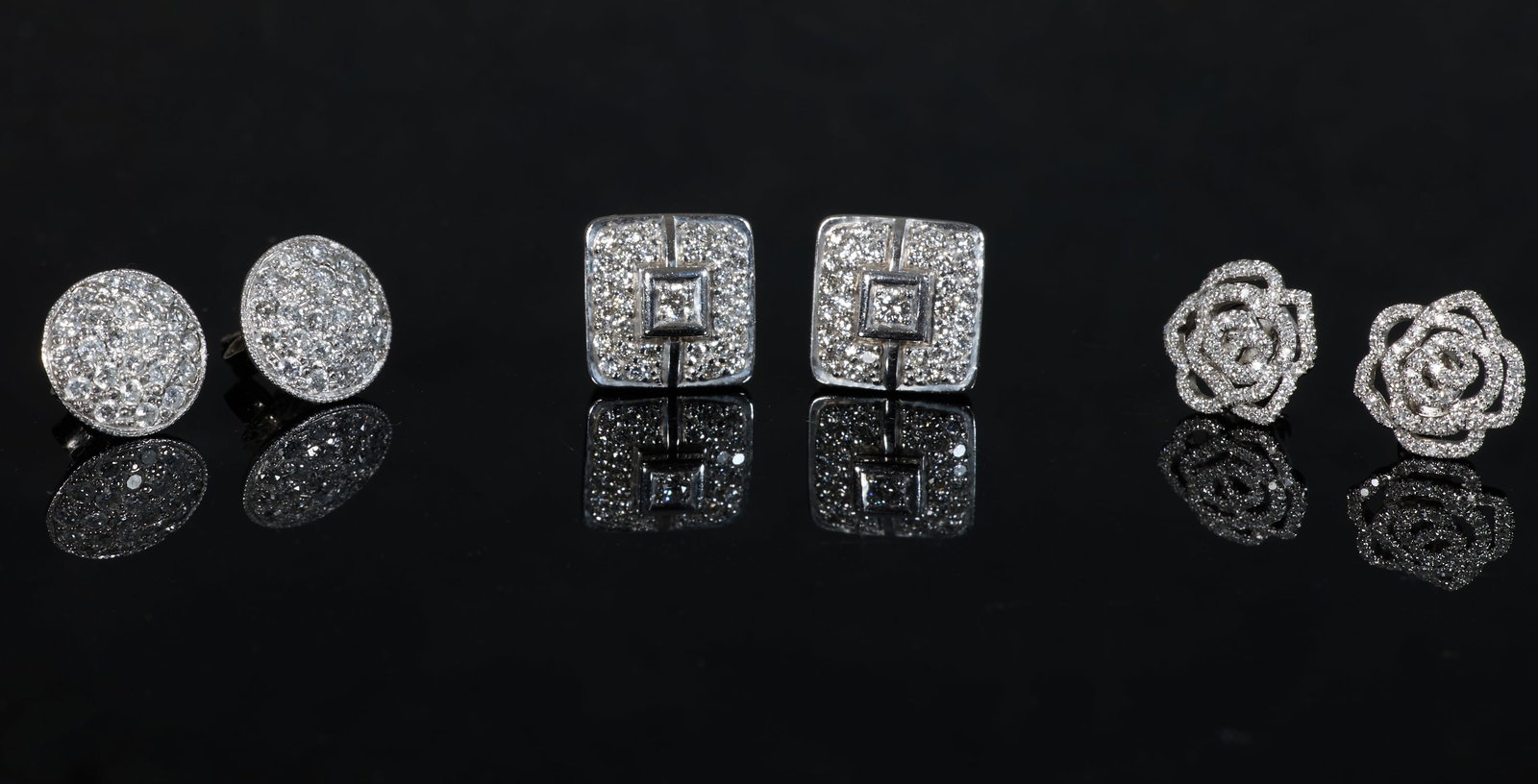 Three Pairs of 14K White Gold Diamond Stud Earrings, App. Total Wt.- 8.7 grams; Square- H.- 11 mm,: Three Pairs of 14K White Gold Diamond Stud Earrings, including a rectangular pair, a round pair, and a floriform pair, all mounted with tiny round white diamonds, App. Total Wt.- 8.7 grams; Square- H.