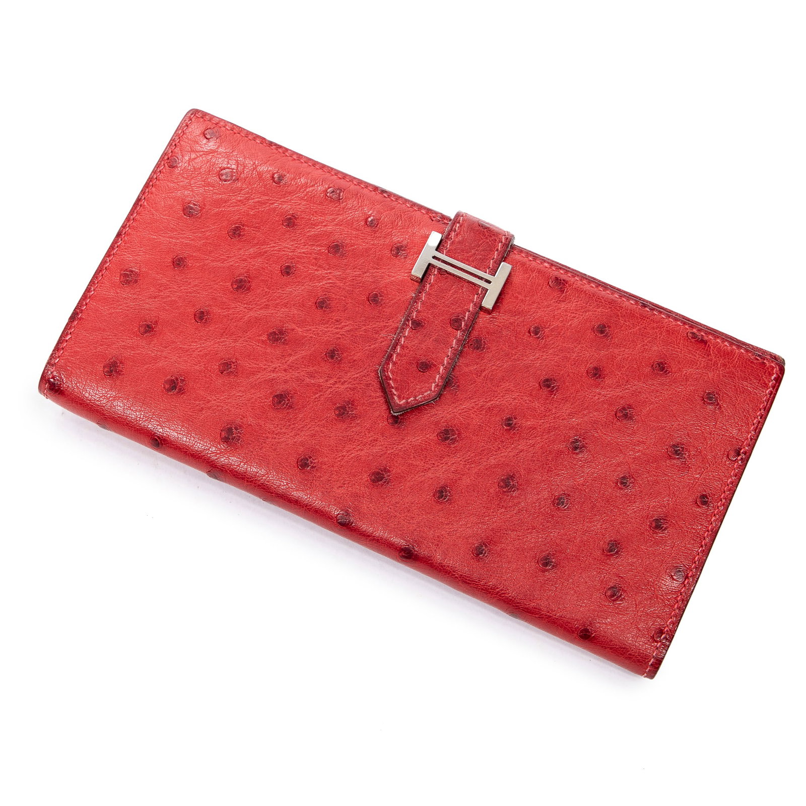 Hermes Bearn Wallet, H.- 3 3/4 in., W.- 6 3/4 in.: Hermes Bearn Wallet, in red ostrich leather, with palladium hardware, strap closure, opening to a matching leather interior with two slot pockets, a card slot pocket and a zip pocket, H.- 3 3/4 in., W