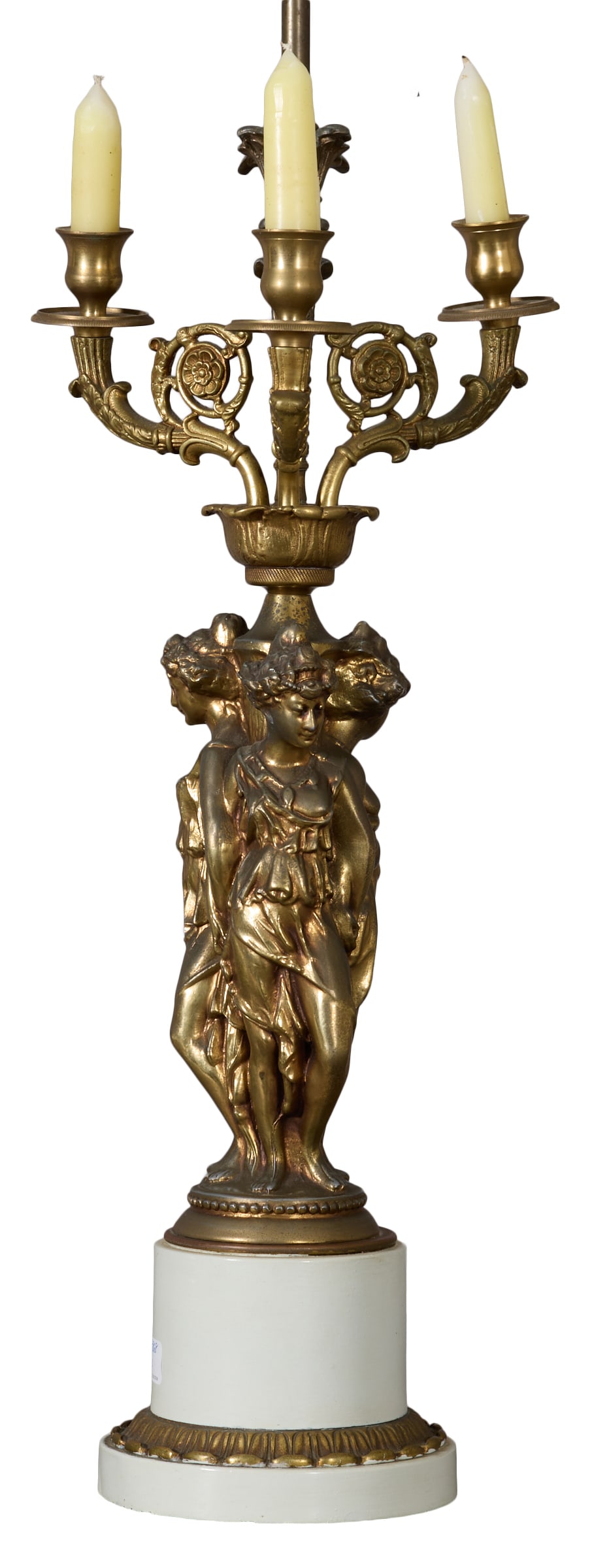 Gilt Bronze Three Muses Lamp, 20th c., H.- 33 in., Dia.- 22 1/2 in.: Gilt Bronze Three Muses Lamp, 20th c., on a white marble columnar support, to a bronze mounted circular base, wired, H.- 33 in., Dia.- 22 1/2 in. Provenance: Collection of Rosemary James, New Orleans 