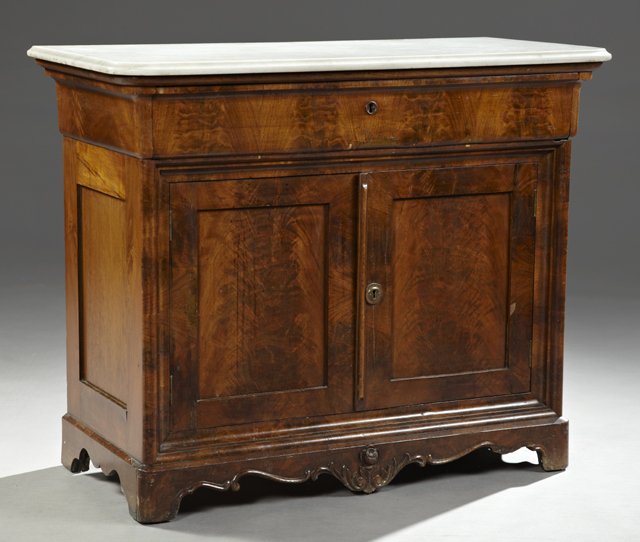 American Carved Walnut Marble Top Server, c. 1890, the: American Carved Walnut Marble Top Server, c. 1890, the rounded corner ogee edge white marble on a base with a frieze drawer over a double cupboard, on a stepped plinth base with a shaped skirt with ce