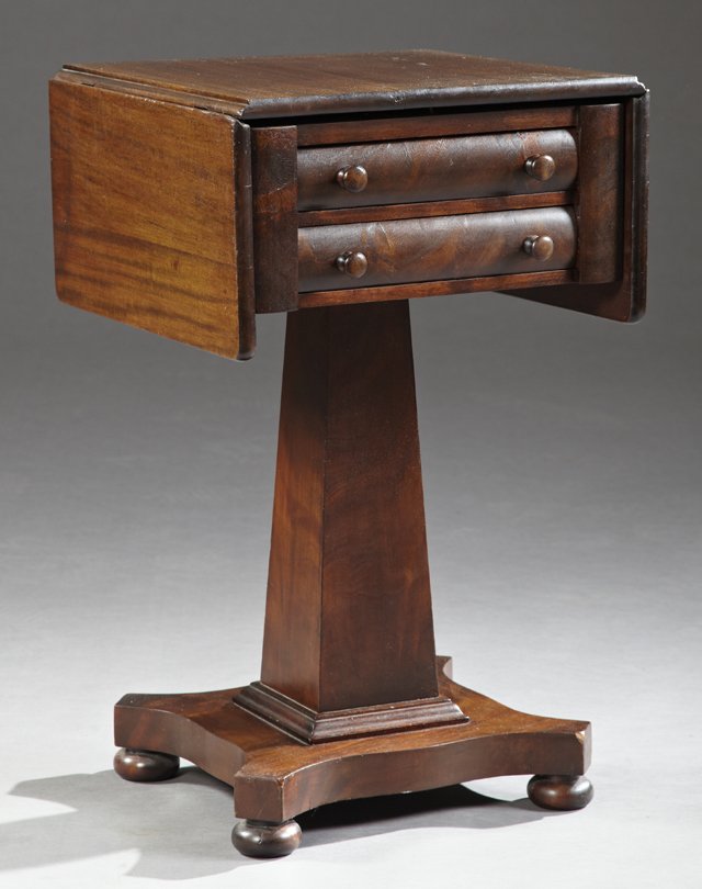 American Classical Carved Mahogany Drop Leaf Work: American Classical Carved Mahogany Drop Leaf Work Table, late 19th c., with two drawers on a tapered square support to a quadruped base on ball feet, H.- 28 1/2 in., W.- Closed- 17 3/4 in., Open- 34 1