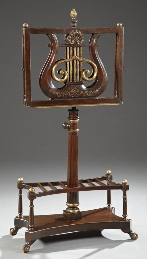 Carved Mahogany and Parcel Gilt Double Sheet Music: Carved Mahogany and Parcel Gilt Double Sheet Music Stand, early 20th c., of adjustable height, on a ring turned support on a shaped base with a music rack, the whole on gilt ball and claw feet, H.- 58