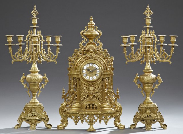 Louis XV Style Brass Three Piece Clock Set, 20th c.,: Louis XV Style Brass Three Piece Clock Set, 20th c., Germany, the clock with an urn surmount over a dial with porcelain chapter marks over a relief lion's head, on five relief cabriole legs together w