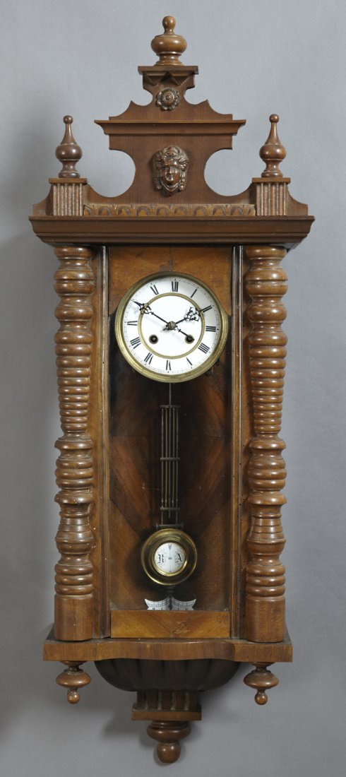 German Carved Mahogany Regulator Wall Clock, 19th c.,: German Carved Mahogany Regulator Wall Clock, 19th c., with a figural crest over an enamel dial, time and strike, H.- 38 1/2 in., W.- 14 3/4 in., D.- 6 in.