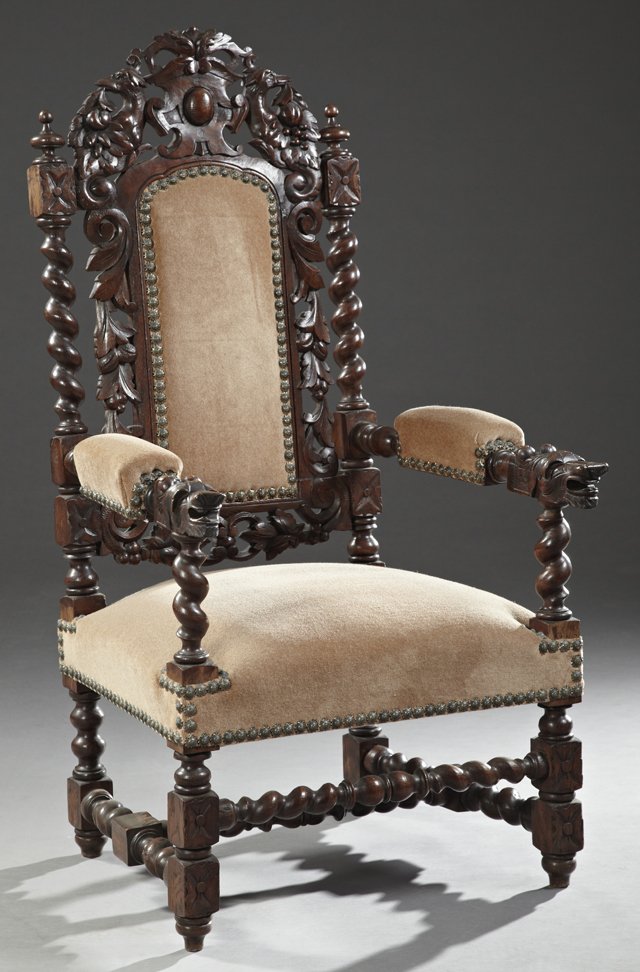 Jacobean Style Carved Oak Upholstered Armchair, 19th: Jacobean Style Carved Oak Upholstered Armchair, 19th c., with a pierced bird and cornucopia crest over an upholstered back flanked by rope twist supports, to lion carved upholstered arms, on bobbin tu