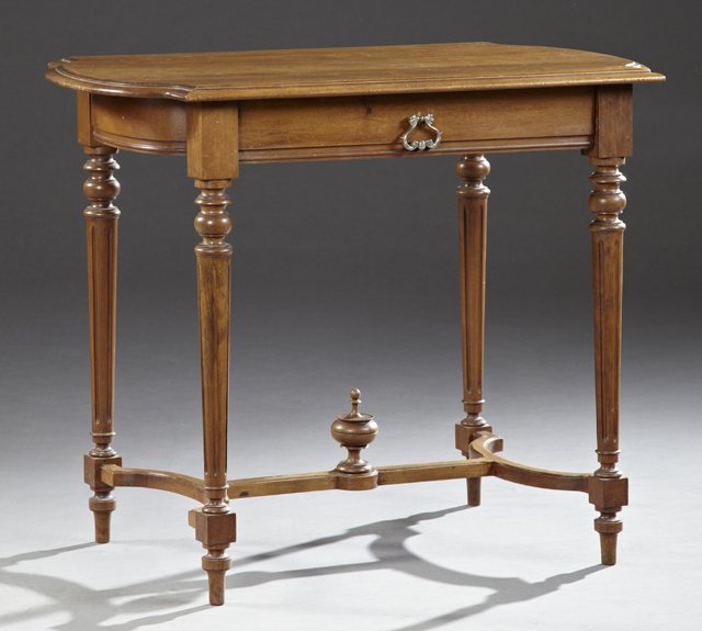 Louis XVI Style Carved Walnut Writing Table, late 19th: Louis XVI Style Carved Walnut Writing Table, late 19th c., the stepped ogee edge elongated top over a frieze drawer, on turned and reeded tapered legs, joined by a curved H-form stretcher with a centr