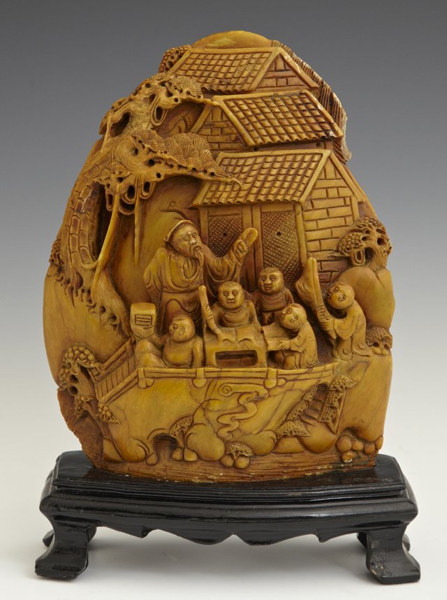 Figural Chinese Carved Soapstone Mountain, early 20th: Figural Chinese Carved Soapstone Mountain, early 20th c., with relief decoration of a student and a teacher, on a custom carved ebonized wood stand, H.- 9 1/2 in., W.- 7 in., D.- 2 1/2 in.