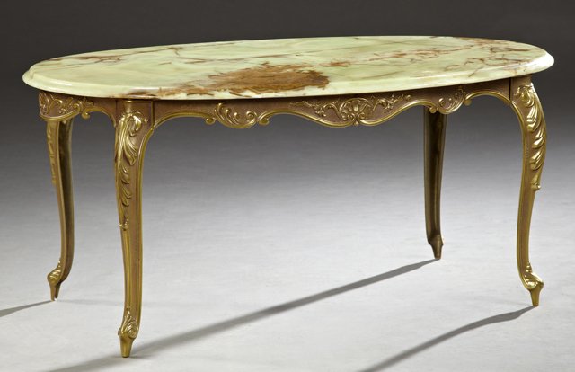 Gilt Bronze and Onyx Coffee Table, 20th c., the ogee: Gilt Bronze and Onyx Coffee Table, 20th c., the ogee edge oval highly figured green onyx top on a base with a relief decorated scrolled skirt, on relief decorated cabriole legs on French toes, H.- 17 