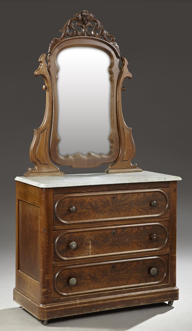 American Carved Mahogany Marble Top Chest, c. 1890, the: American Carved Mahogany Marble Top Chest, c. 1890, the arched shaped mirror with a pierced leaf and nut crest, on a base with an ogee white marble over three drawers, H.- 89 in., W.- 42 in., D.- 19 i