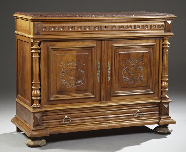 Henri II Style Carved Walnut Marble Top Sideboard, 19th: Henri II Style Carved Walnut Marble Top Sideboard, 19th c., the inset highly figured rouge marble over a reeded and floral carved frieze drawer, above double carved fielded panel cupboard doors openin
