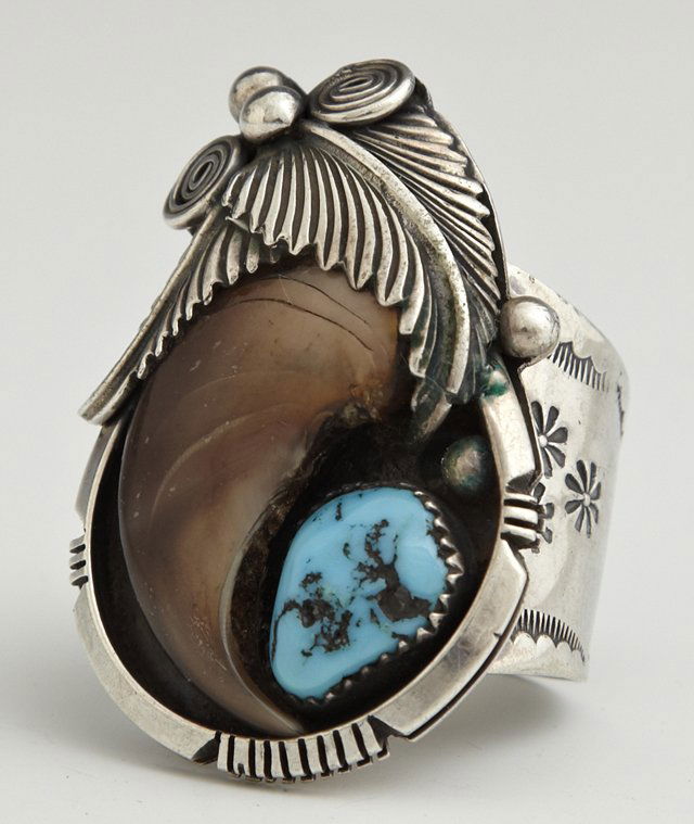 Native American Sterling Man's Ring, 20th c., mounted: Native American Sterling Man's Ring, 20th c., mounted with a bear claw and a turquoise nugget, the sides of the band with punched floral decoration, size 13 1/2.