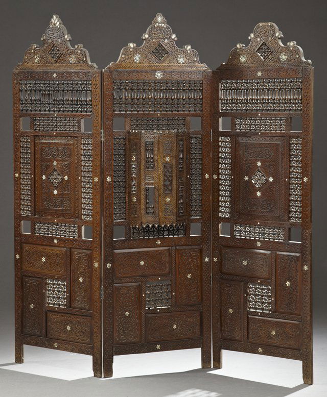 Moroccan Highly Carved Three Panel Dressing Screen,: Moroccan Highly Carved Three Panel Dressing Screen, early 20th c., with turned spindles and mother-of-pearl inlay, the center panel with a bowed opening window, H.- 74 1/2 in., W.- each panel- 24 in.,