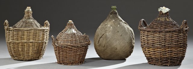 Group of Four Mold Blown Glass Wine Carboys, 19th c.,: Group of Four Mold Blown Glass Wine Carboys, 19th c., three in fitted woven wicker baskets, one covered in stitched burlap, Burlap- H.- 21 in., Dia.- 15 in.