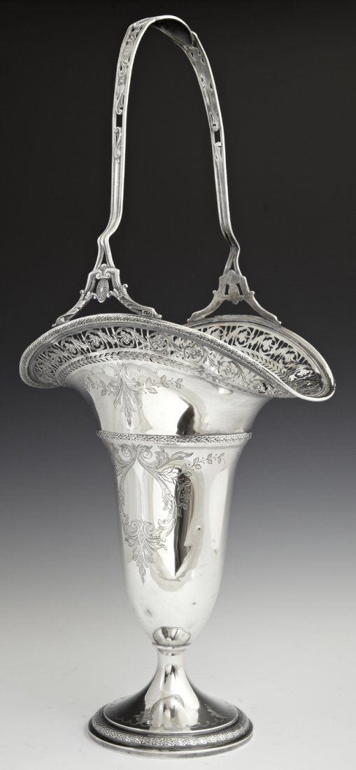 Weighted Sterling Center Basket, c. 1920, by the Watson: Weighted Sterling Center Basket, c. 1920, by the Watson Co., with a pierced handle and a reticulated border, the sides with engraved decoration, H.- 21 in., W.- 9 3/4 in., D.- 7 1/8 in.