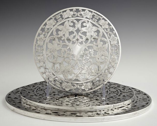 Set of Three Graduated Art Nouveau Sterling Overlay: Set of Three Graduated Art Nouveau Sterling Overlay Glass Trivets, early 20th c., by Webster, with floral decoration, Largest- Dia.- 10 1/8 in.