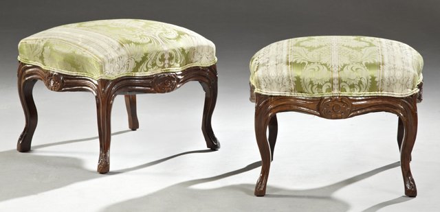 Pair of Louis XV Style Carved Rosewood Upholstered: Pair of Louis XV Style Carved Rosewood Upholstered Footstools, early 20th c., the reeded skirts with central leaf scroll cartouches, on cabriole legs with leaf carved feet, H.- 14 1/2 in., W.- 17 1/2 