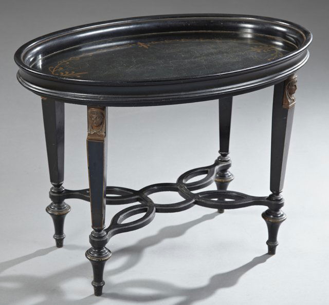 Empire Style Ebonized Wood and Glass Oval Tray Top: Empire Style Ebonized Wood and Glass Oval Tray Top Coffee Table, 20th c., on tapered square legs with ormolu classical head capitals, on turned tapered legs joined by a shaped pierced stretcher, H.- 2