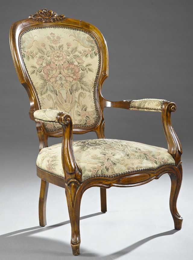 American Carved Beech Victorian Style Library Chair,: American Carved Beech Victorian Style Library Chair, early 20th c., with a carved leaf crest over a shield back, to upholstered arms and a bowed seat, on cabriole legs to French toes, H.- 41 1/2 in.