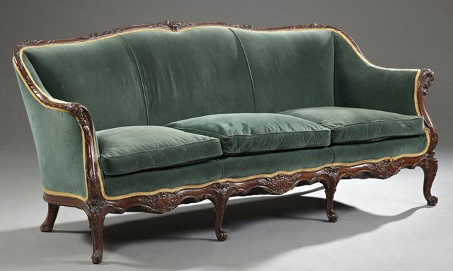 Carved Mahogany Victorian Style Triple Seat Settee,: Carved Mahogany Victorian Style Triple Seat Settee, early 20th c., with a floral carved crest rail and floral carved scrolled arms, on cabriole legs joined by a floral carved skirt, to scrolled toes, 