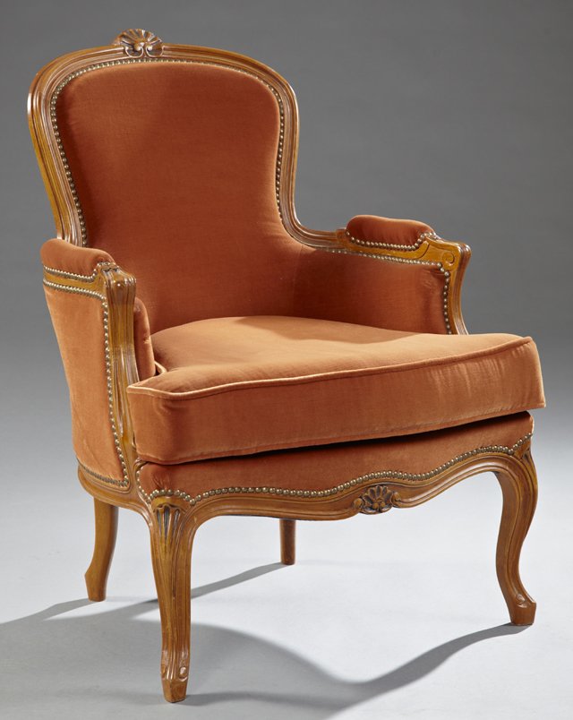 Louis XV Style Carved Cherry Bergere, 20th c., the: Louis XV Style Carved Cherry Bergere, 20th c., the arched reeded back with central shell carving, over upholstered reeded arms to a bowed seat over a shell carved skirt, on reeded cabriole legs to Fre