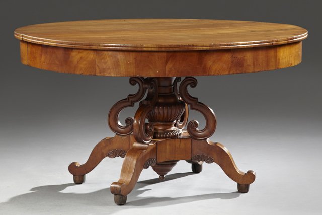 French Oval Carved Cherry Dining Table, 19th c., with a: French Oval Carved Cherry Dining Table, 19th c., with a wide skirt and a large carved urn support to a quadruped base on cabriole legs, the leaves not present, H.- 29 1/2 in., W.- 54 1/4 in., D.- 46 i