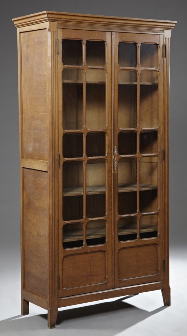 Louis Philippe Style Oak and Beech Double Door: Louis Philippe Style Oak and Beech Double Door Bookcase, early 20th c., with a stepped ogee crown over mullioned glazed doors flanked by reeded pilasters, on tapered flat legs, H.- 78 1/2 in., W.- 42 