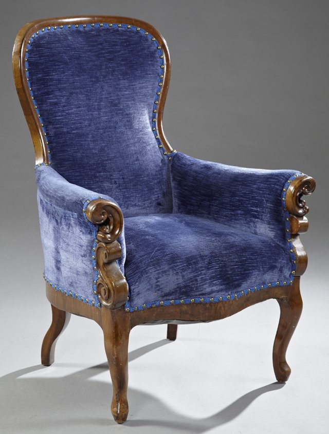 American Rococo Revival Carved Rosewood Bergere, 19th: American Rococo Revival Carved Rosewood Bergere, 19th c., with c-scroll carved arms, on cabriole legs joined by a shaped skirt, in blue velvet and brass tack upholstery, H.- 40 3/4 in.