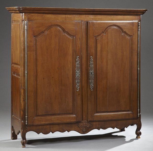 Unusual Diminutive Louis XV Style Carved Cherry: Unusual Diminutive Louis XV Style Carved Cherry Armoire, early 19th c., with a stepped ogee crown over double fielded panel doors with long steel escutcheons and fiche hinges, separated by a reeded pi