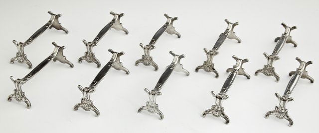 Set of Ten Christofle Silverplated Knife Rests, early: Set of Ten Christofle Silverplated Knife Rests, early 20th c., with relief leaf and floral decoration, H.- 1 1/2 in., W.- 3 7/8 in., D.- 1 1/4 in.