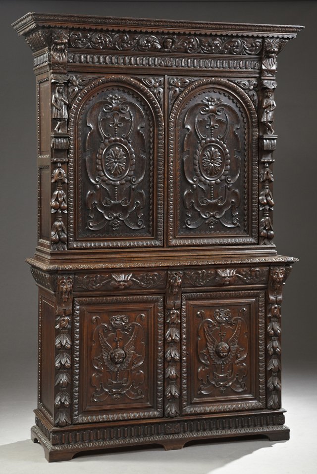 Jacobean Style Carved Oak Buffet a Deux Corps, 19th c.,: Jacobean Style Carved Oak Buffet a Deux Corps, 19th c., the ogee crown over a leaf carved frieze with a central angel's head, over arched floral and scroll carved double doors flanked by figural, leaf