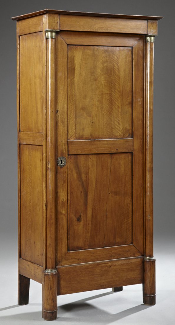 Diminutive French Empire Style Bronze Mounted Carved: Diminutive French Empire Style Bronze Mounted Carved Cherry Bonnetiere, c. 1850, with an ogee crown over a double panel door flanked by bronze mounted half columns, on tall cylindrical legs, H.- 64 1/