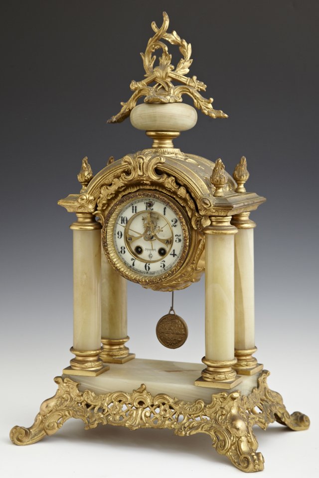 Gilt Spelter and Green Onyx French Style Portico Clock,: Gilt Spelter and Green Onyx French Style Portico Clock, , late 19th c., by Gilbert, the onyx ball top mounted with a gilt leaf, torch and quiver surmount, over an enamel dial open escapement clock, ti