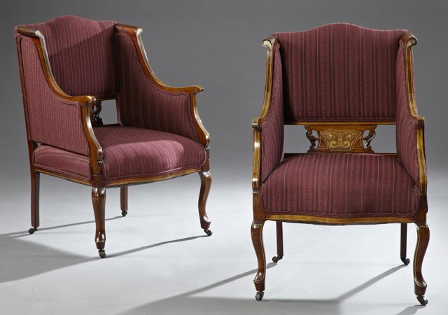 Pair of Edwardian Carved Mahogany Bergeres, c. 1910,: Pair of Edwardian Carved Mahogany Bergeres, c. 1910, with celluloid and line inlay, the upholstered backs over pierced inlaid supports, with bowed seats on cabriole Queen Anne legs to pad feet, H.- 36