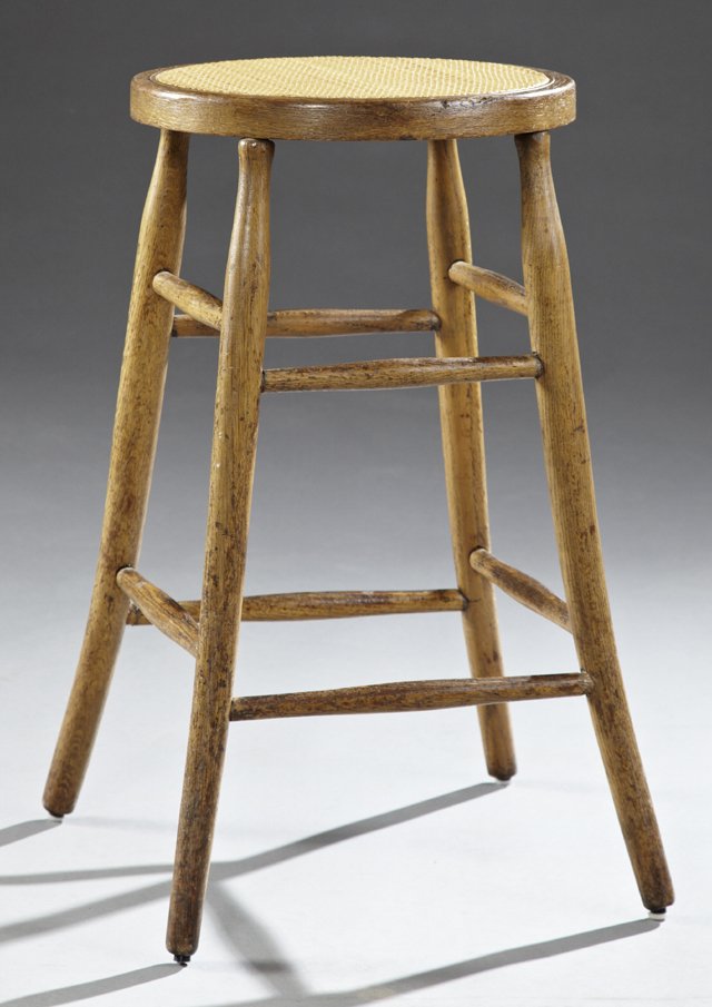 Heywood Wakefield Oak Bentwood Stool, early 20th c.,: Heywood Wakefield Oak Bentwood Stool, early 20th c., with a rattan seat, on tapered splayed cylindrical legs joined by cylindrical stretchers, with a partial paper label, "Heywood Brothers Wakefield C