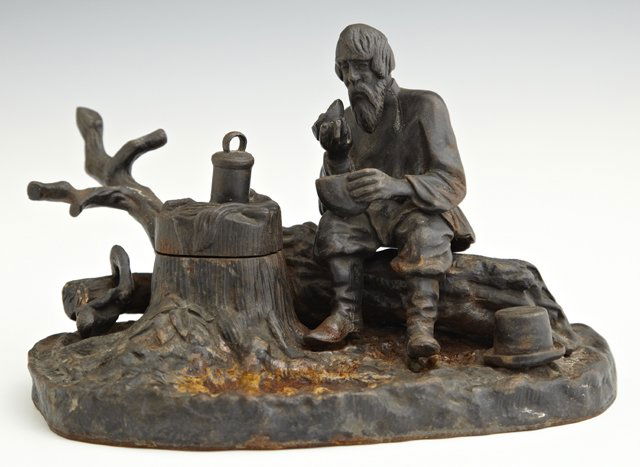 Russian Cast Iron Figural Inkwell, 20th c., the rear: Russian Cast Iron Figural Inkwell, 20th c., the rear with a branch form pen holder, with an impressed Cyrillic maker's mark left, H.- 5 1/2 in., W.- 8 1/4 in., D.- 6 3/4 in.